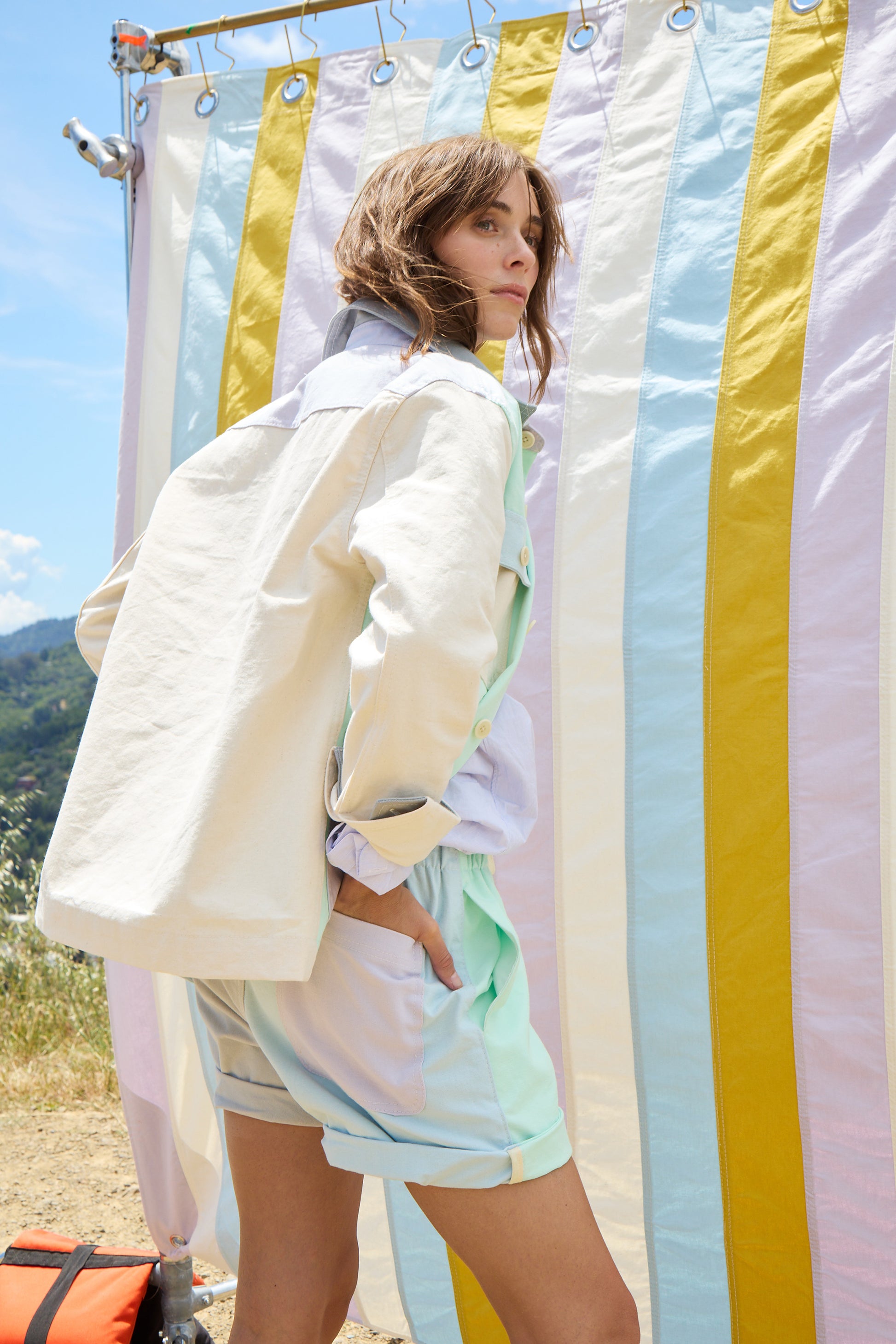 woman facing the back wearing a cream jacket