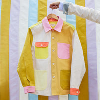 Colorful jacket on a hanger against a striped background
