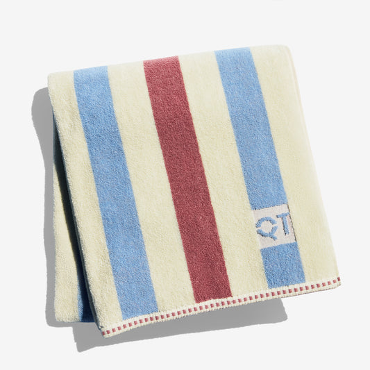 Striped towel with blue, rose, and cream stripes on a white background