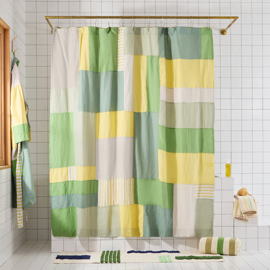 green and yellow pacthwork shower curtain in a bathroom setting