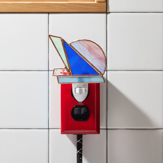Decorative night light with stained glass design on a tiled wall