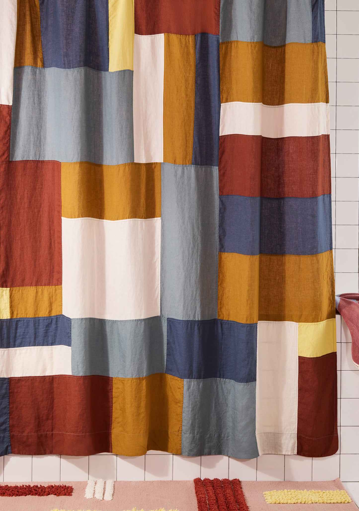 multicolor linen curtain hanging in white bathroom. 