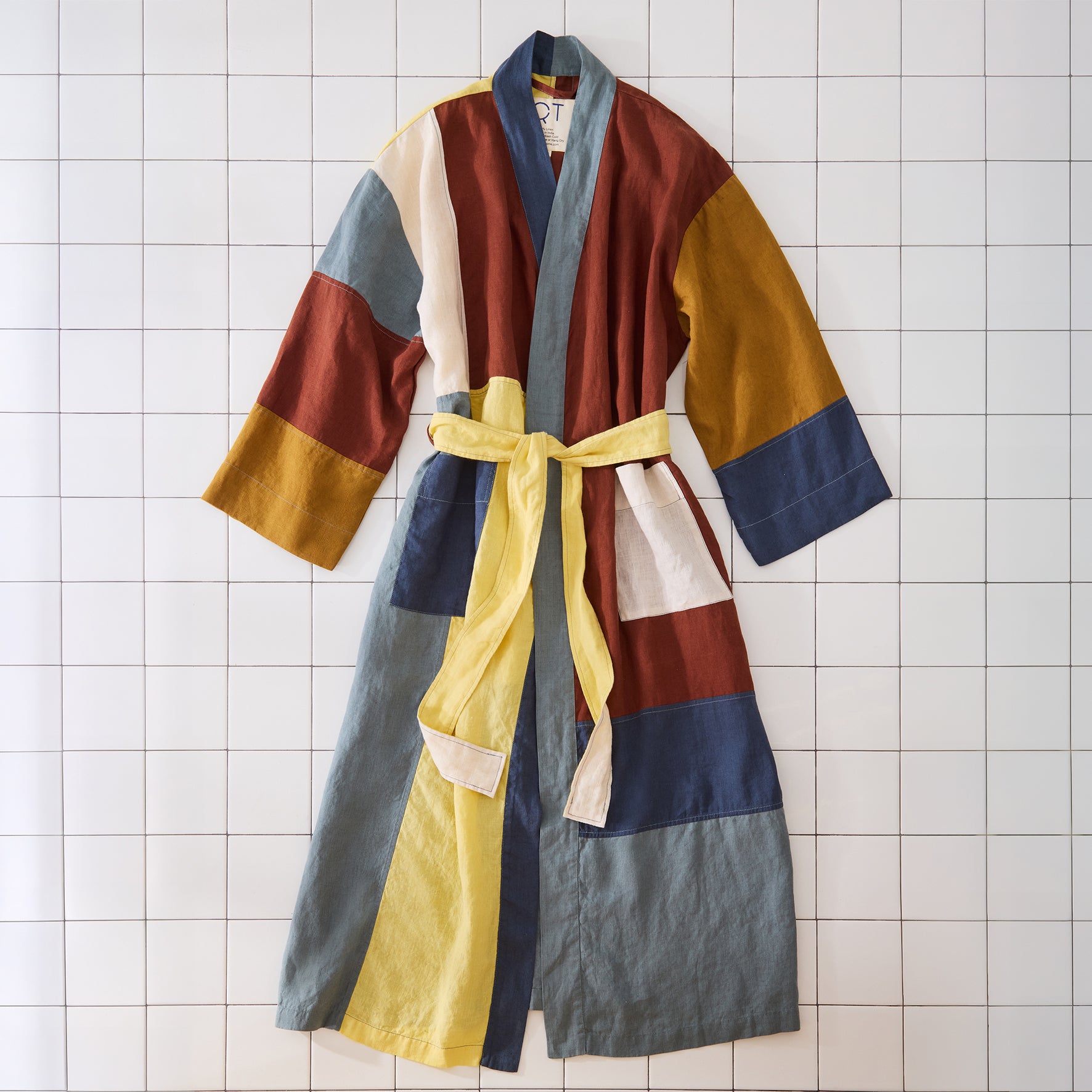 Colorful robe with a yellow belt on a tiled floor