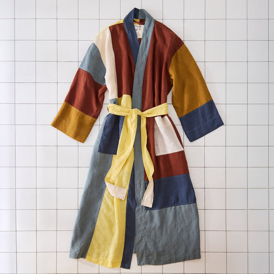 Colorful robe with a yellow belt on a tiled floor