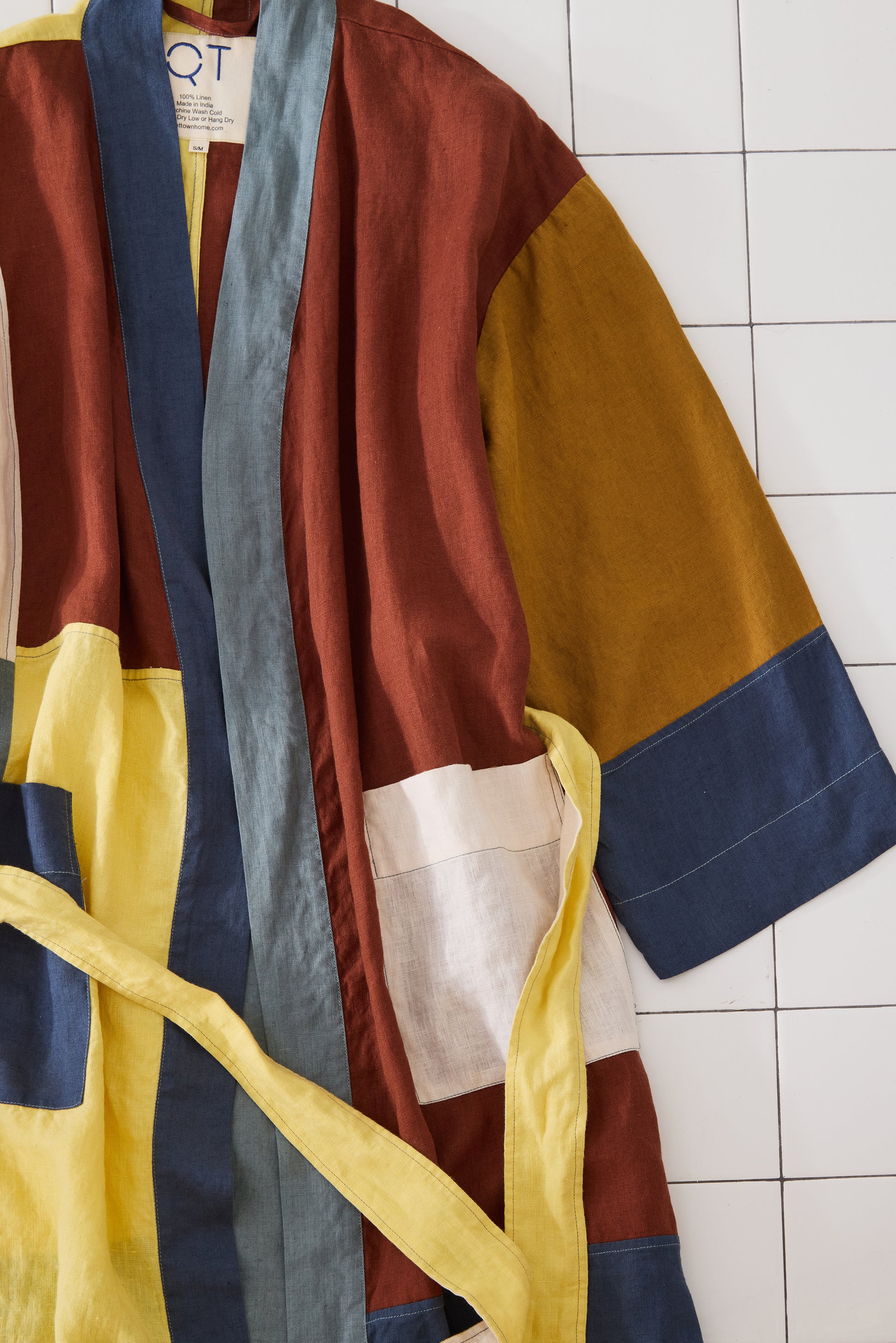 Colorful robe with patchwork design on a tiled floor