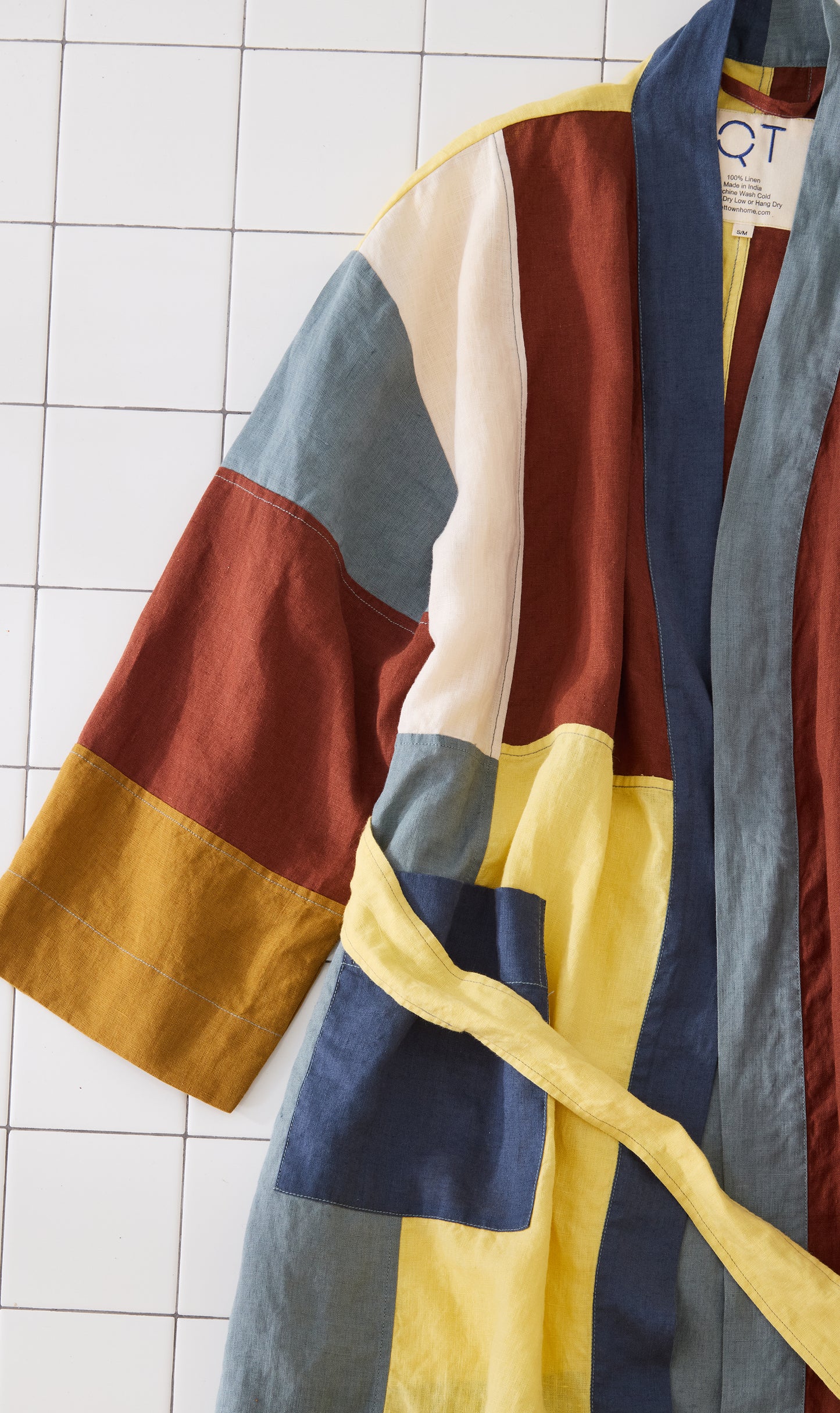 Color-blocked jacket with a geometric pattern on a tiled background