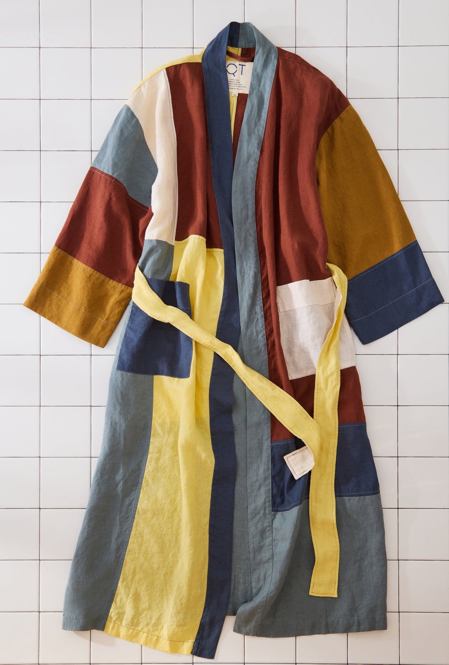 Colorful robe with a yellow belt on a tiled floor