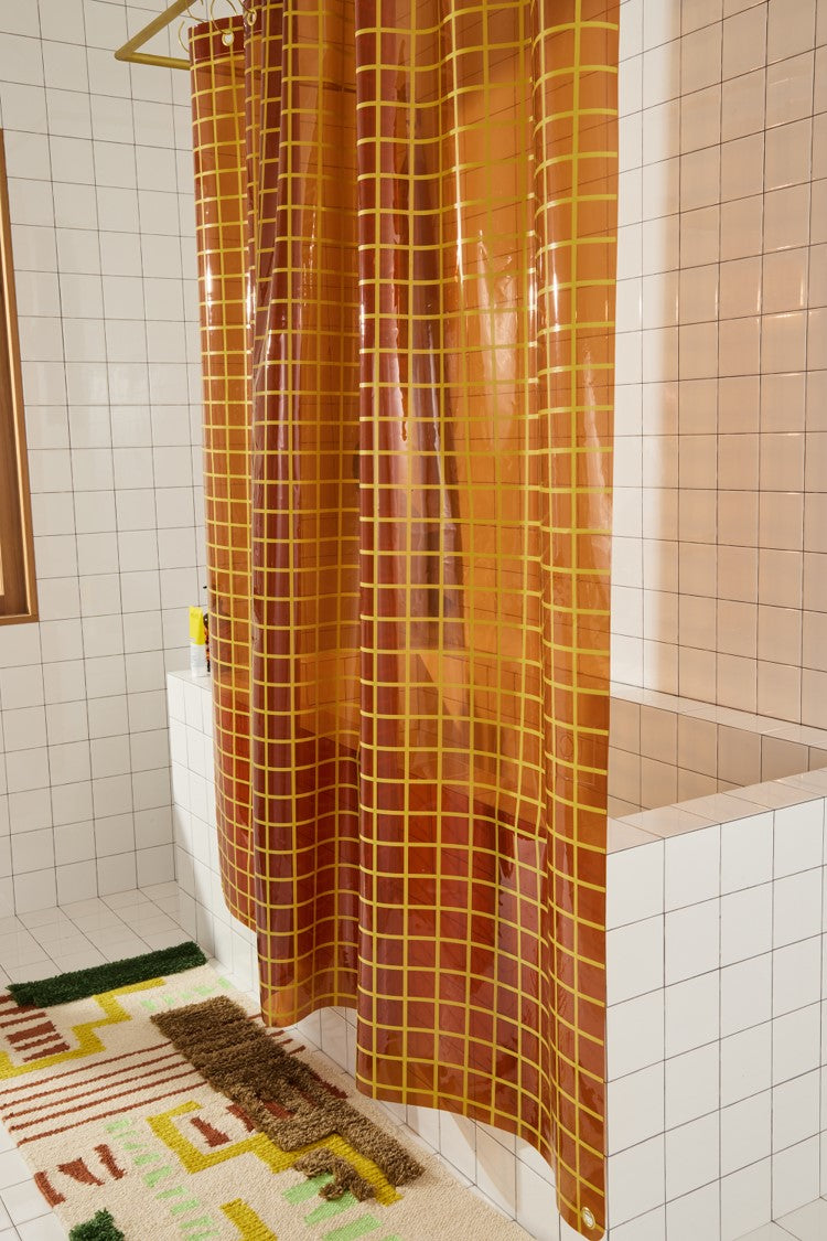 Sun Shower in Honey 2x2 side view of curtain hanging in a bathroom.