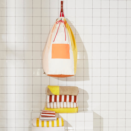 Re:Canvas Laundry Bag Clay Hanging on bathroom wall