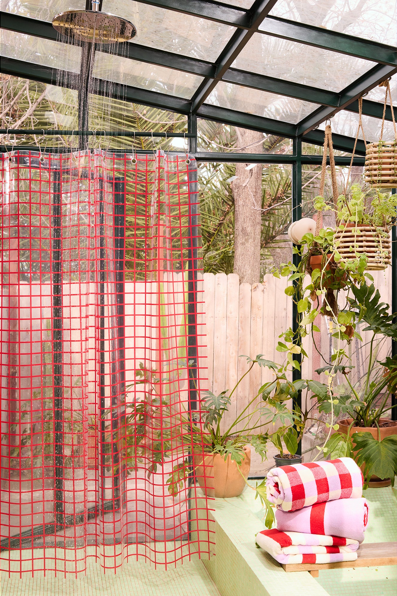 red clear grid curtain in a green bathroom.