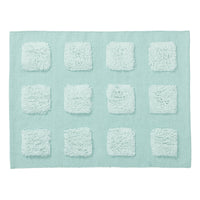 mint green textured bath rug on a white background. 