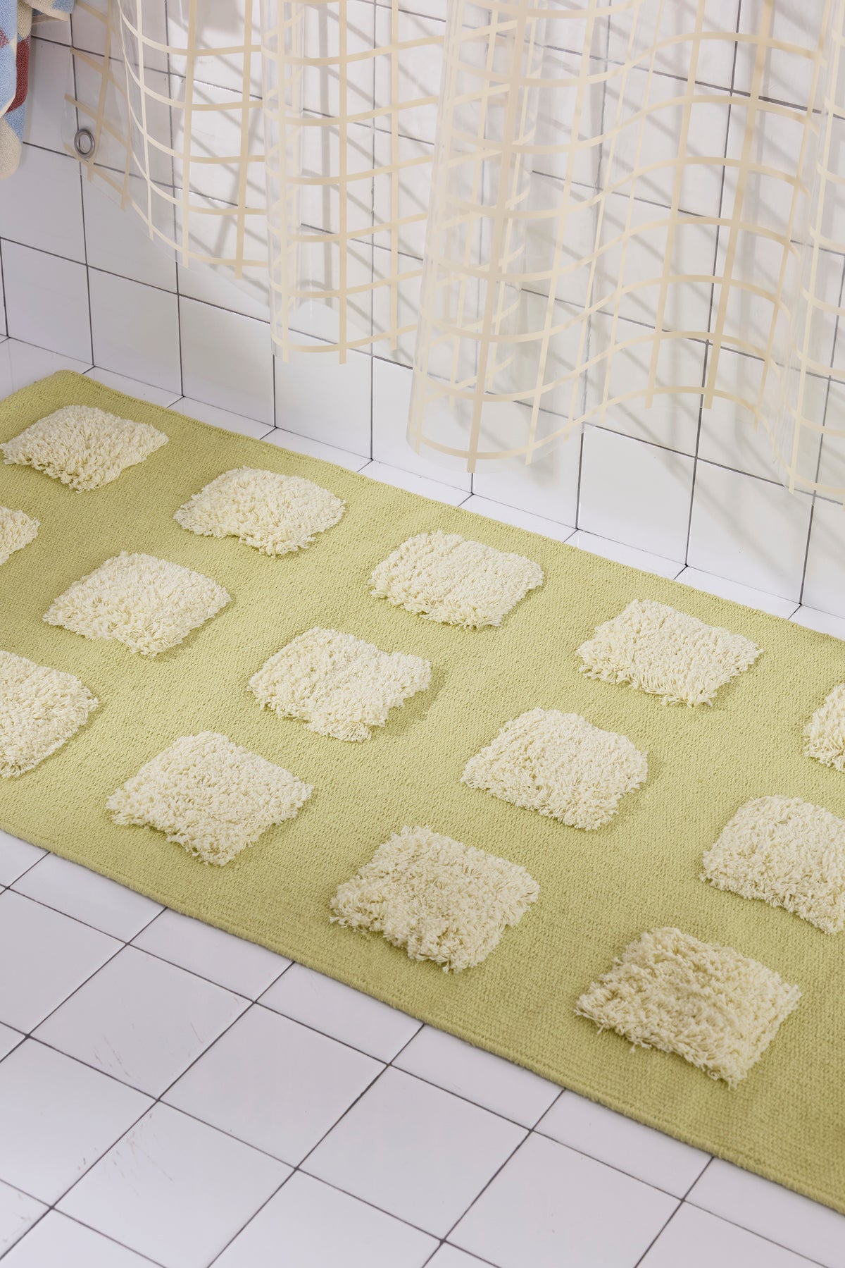 A yellow/olive woven runner featuring 21 raised, natural-colored textured rectangular tufts arranged in a 7-by-3 grid pattern.