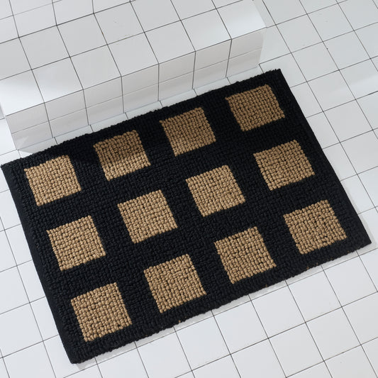 black and tan check rug on white tiled floor with steps. 