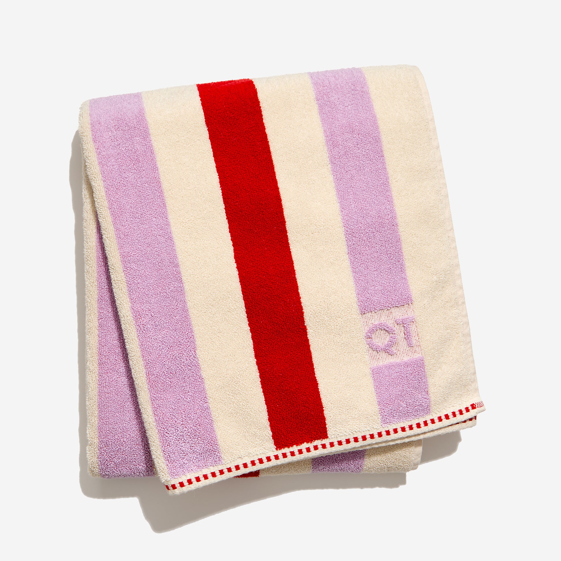 striped towel with red, purple, and cream colors on a white background