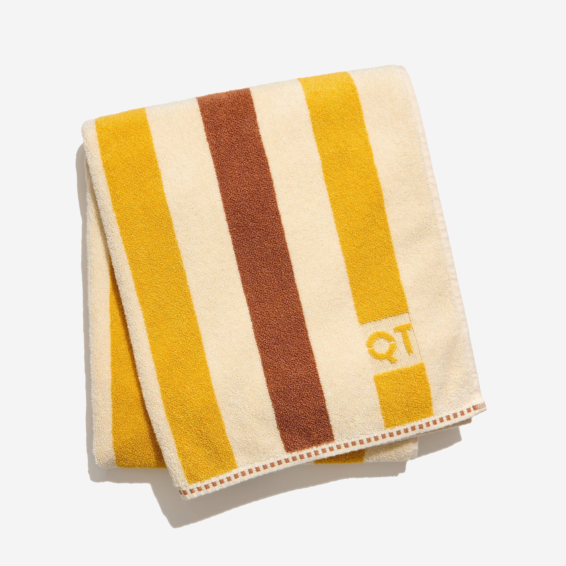 Folded towel with yellow and brown stripes on a white background