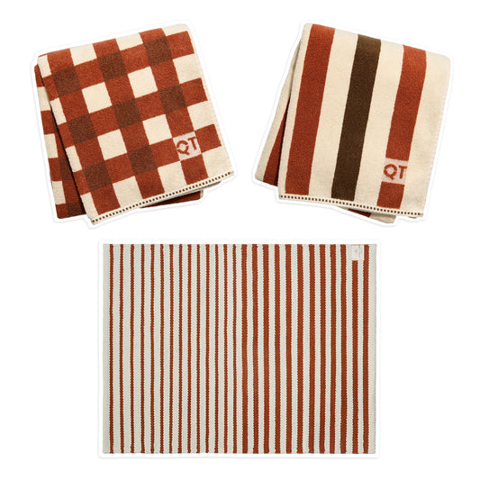 two patterned towels and 1 striped rug on white background
