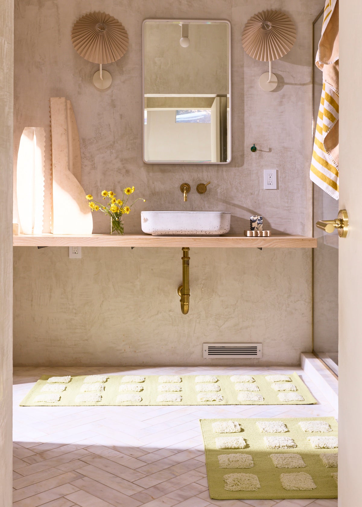 Lime green runner and mat with square texture in a cream bathroom. 