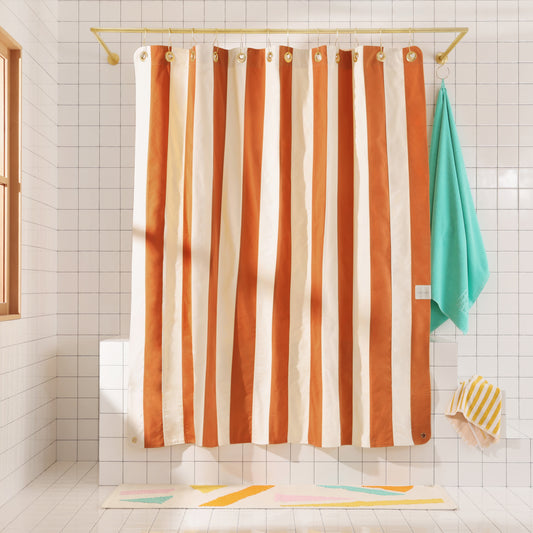 Clay and Natural striped canvas curtain hanging in white tiled bathroom set 