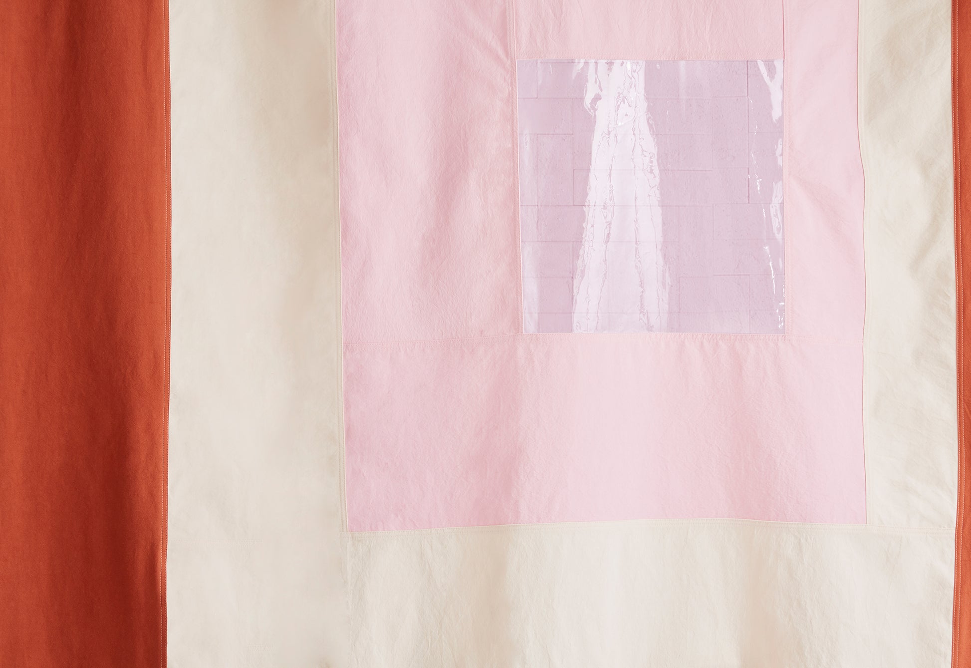 tight cropped photo of clear pink center of curtain