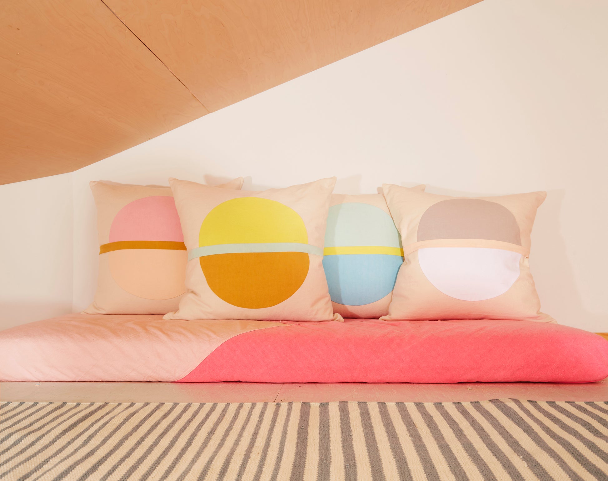 Re:Canvas Arco Sand Square Pillow placed in bed