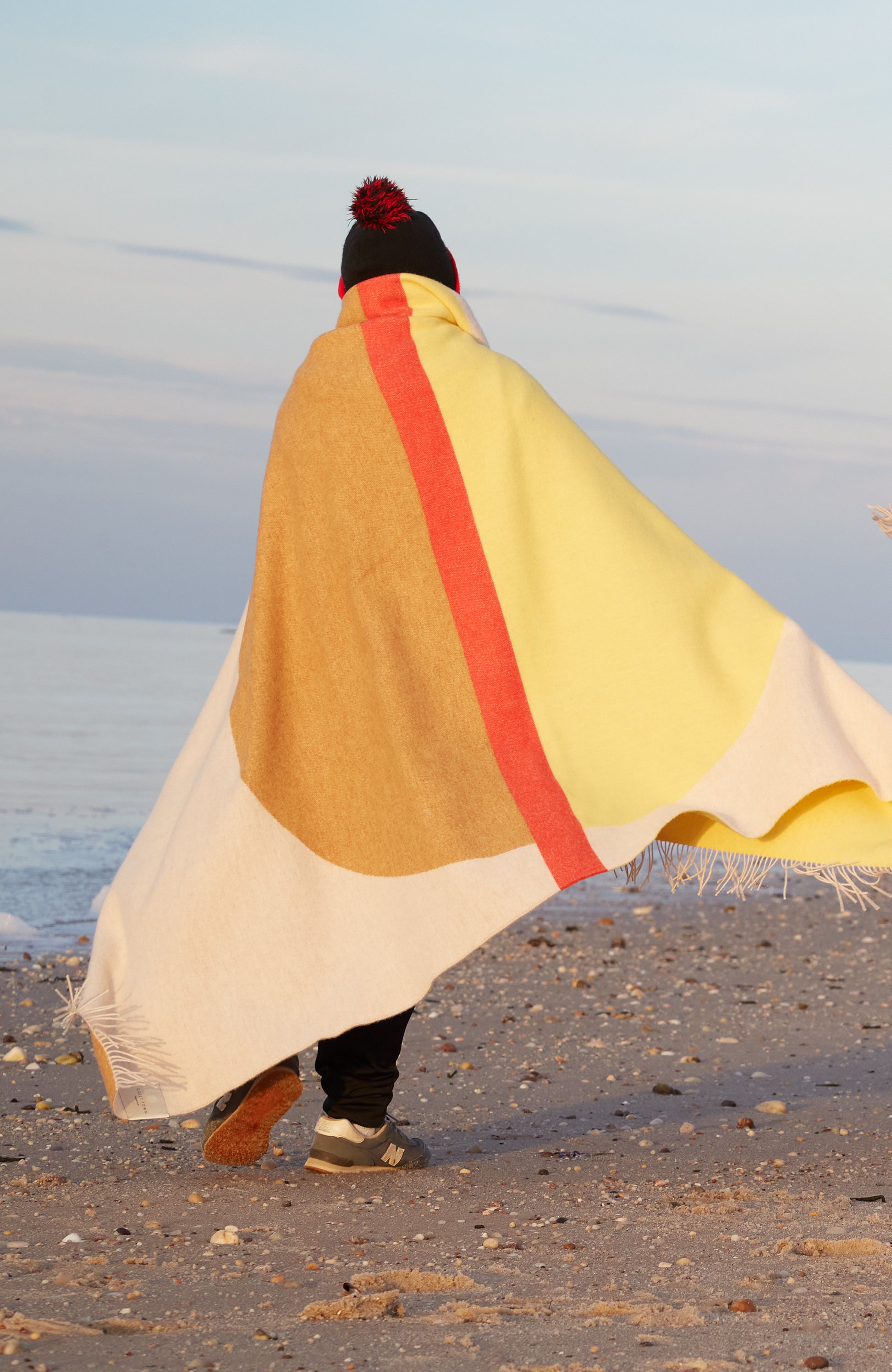 Arco Hike Blanket wrapped on a person on beach