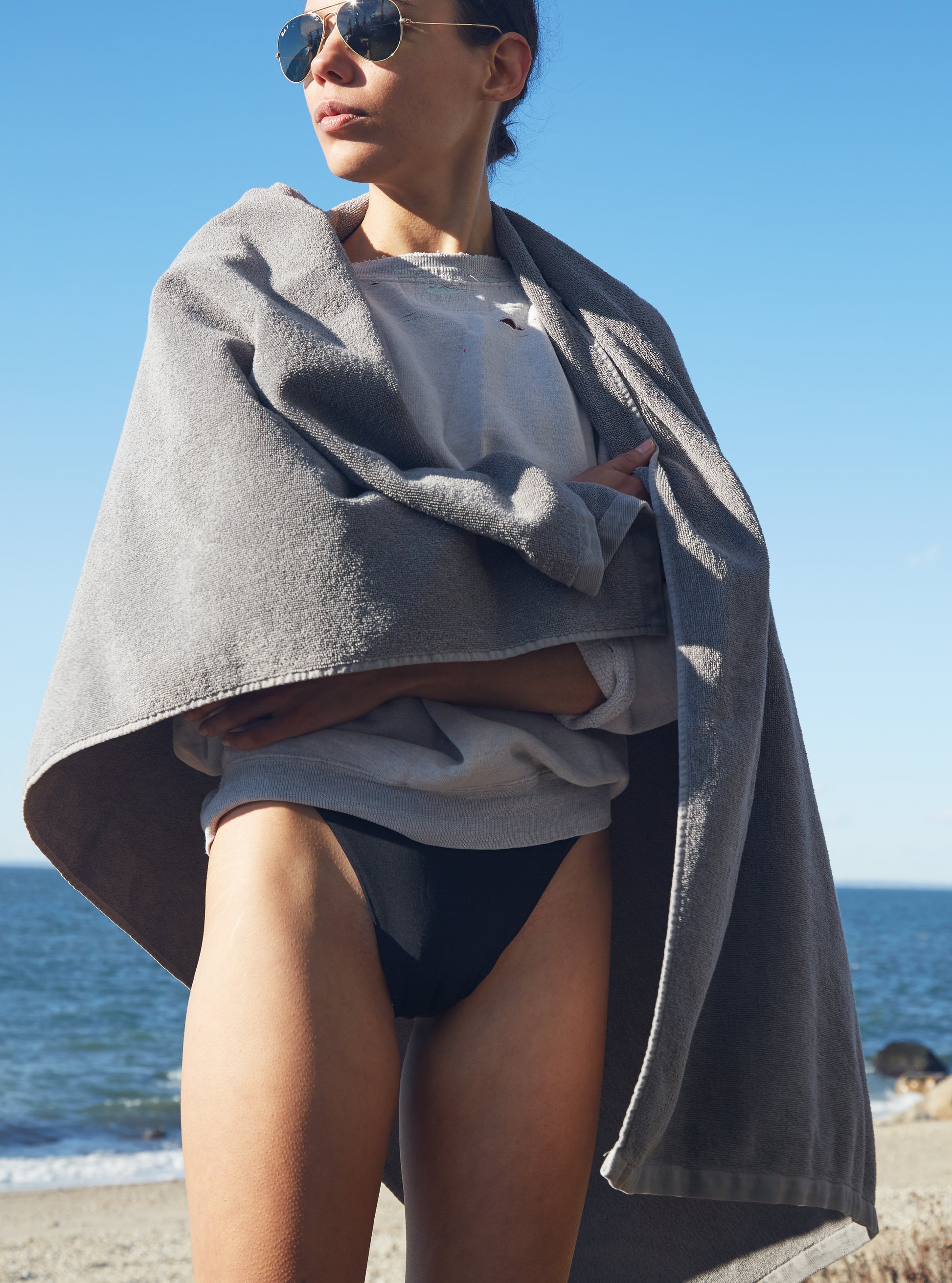 Quiet Towel Storm wrapped around a person on beach